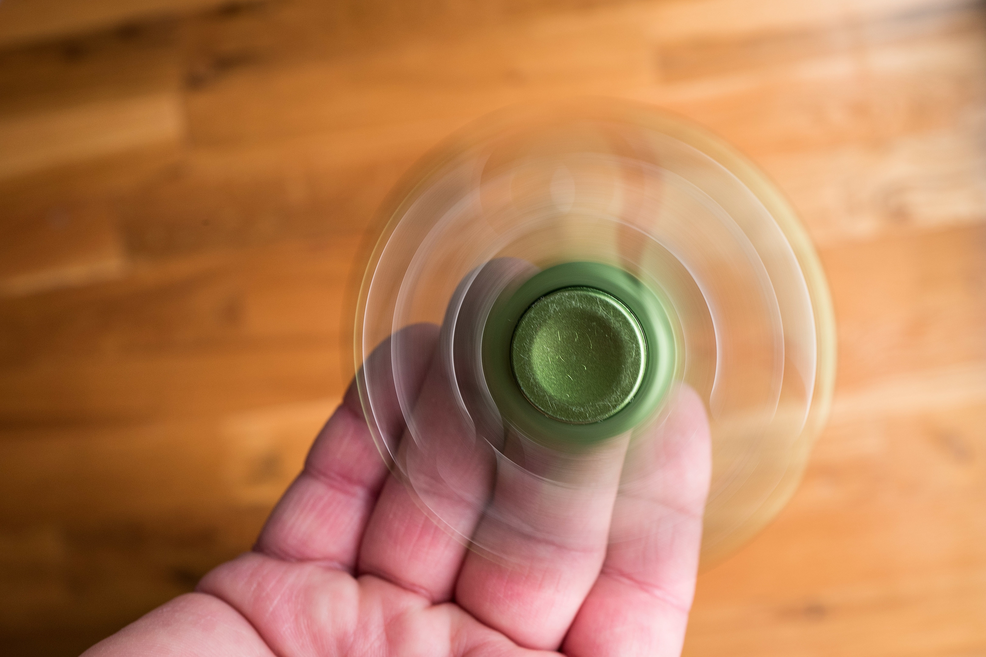 A man spins a fidget spinner.