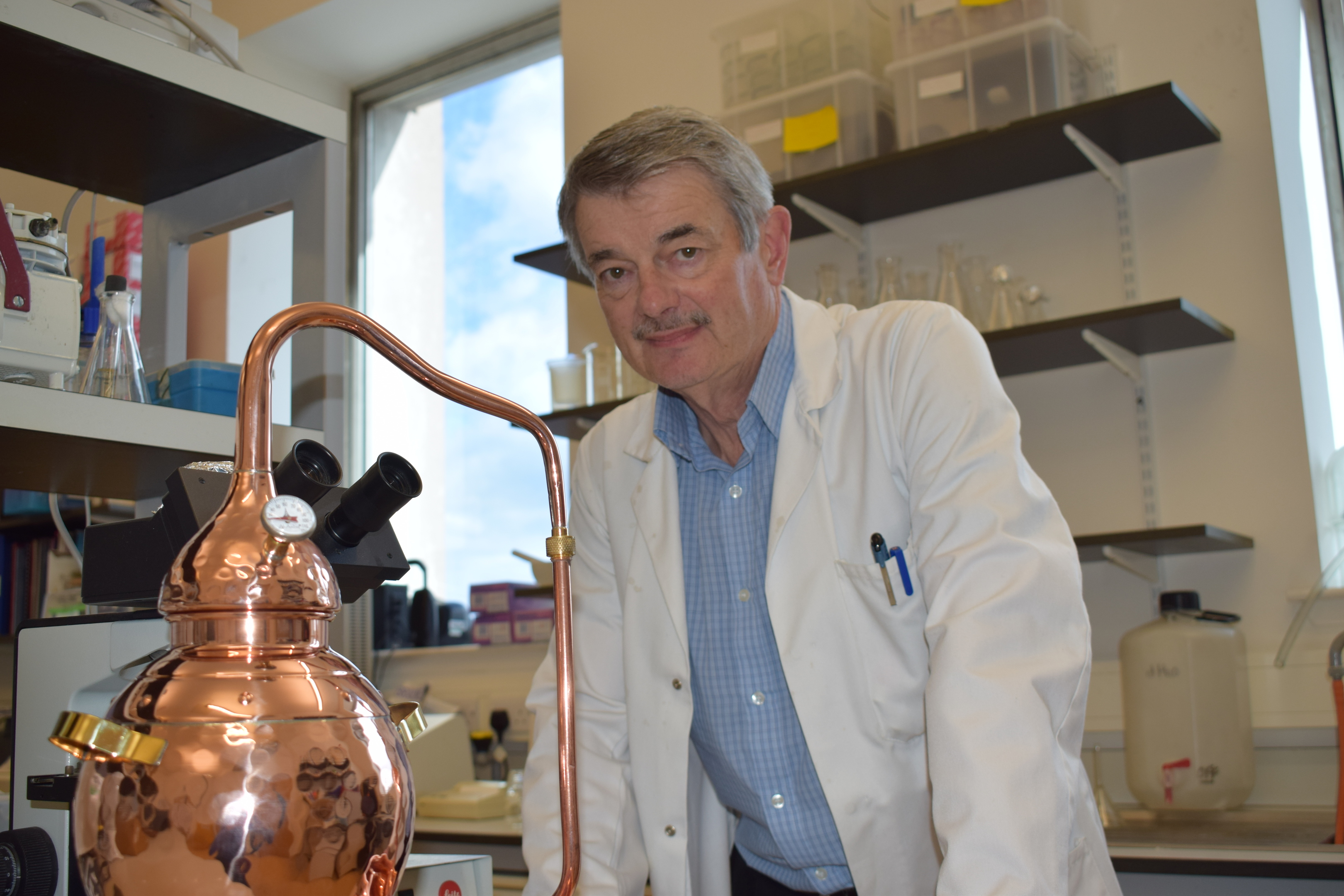 Professor Graeme Walker with a mini distillation device.