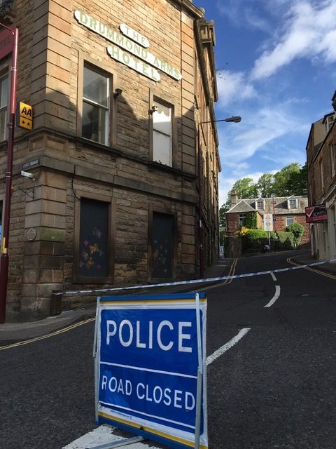 Police road closed sign outside Drummond Arms Hotel in 2019.