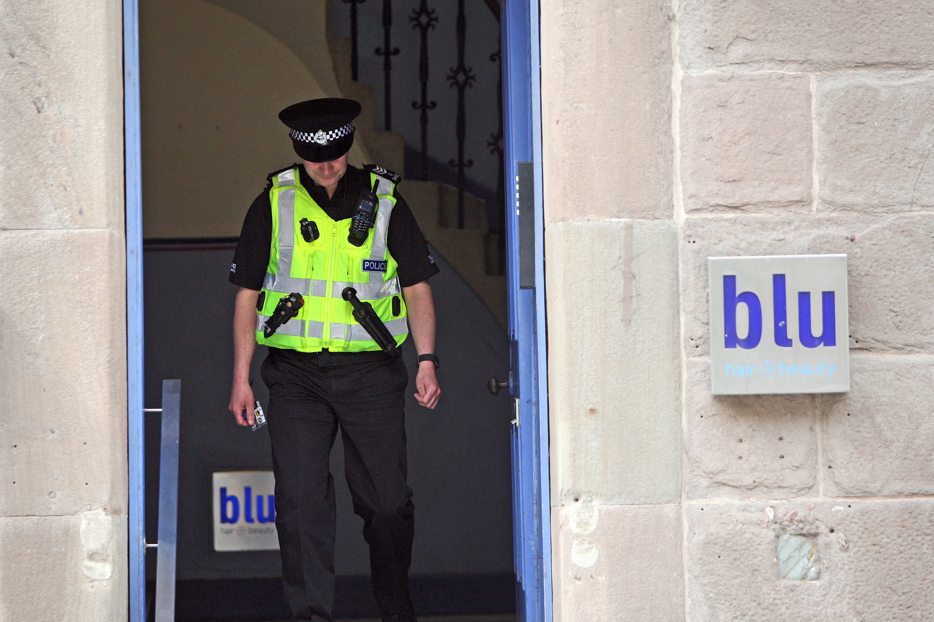 A policeman in the common close beside Blu hairdressing in South Tay Street.