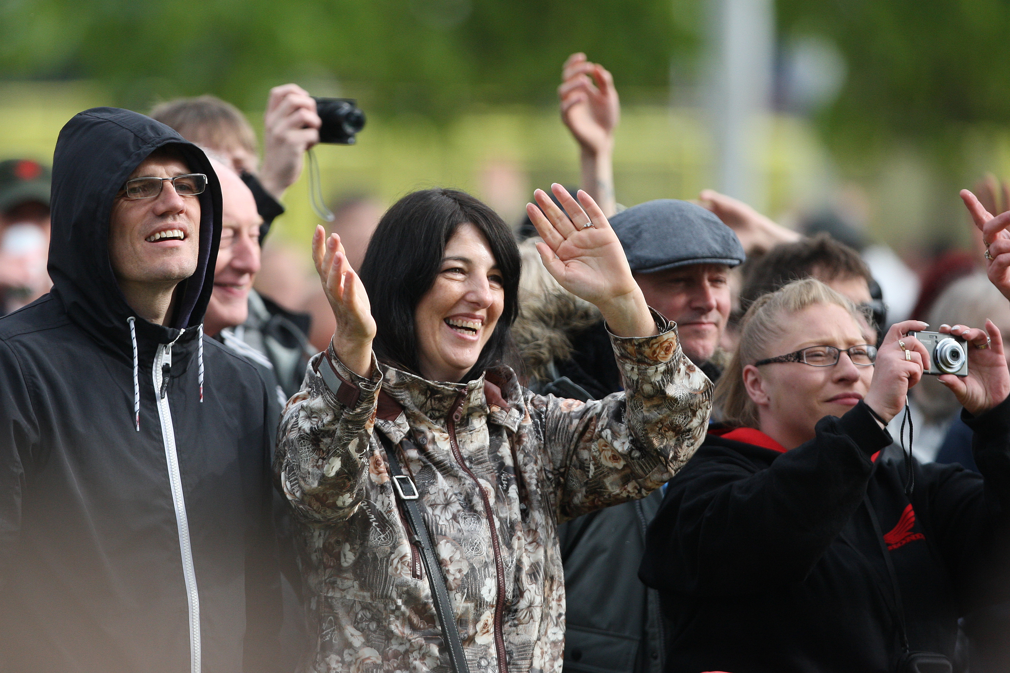 Fans enjoying the show in rain and shine.