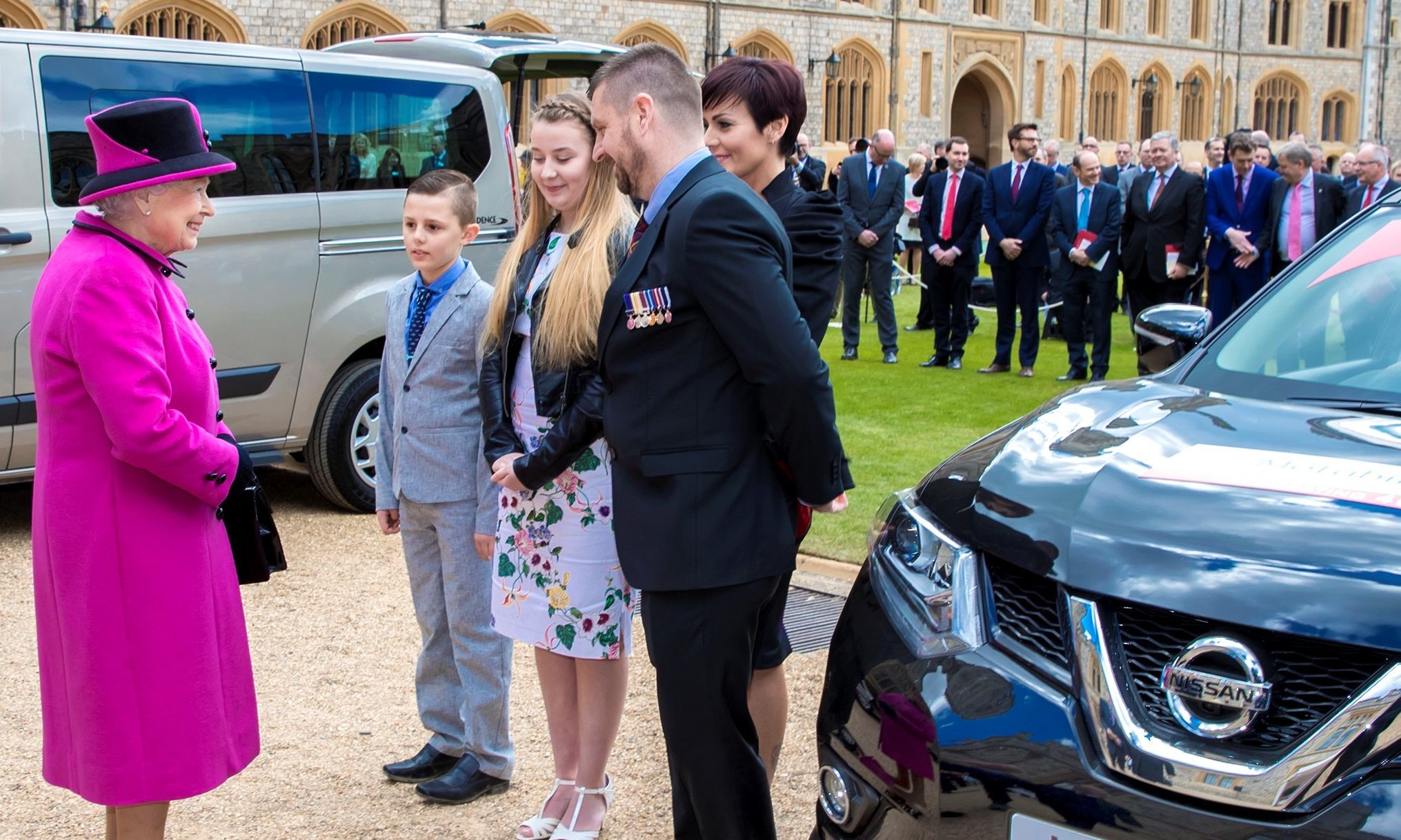 The Queen meets Paul and his family to present the keys to the new Motability vehicle.