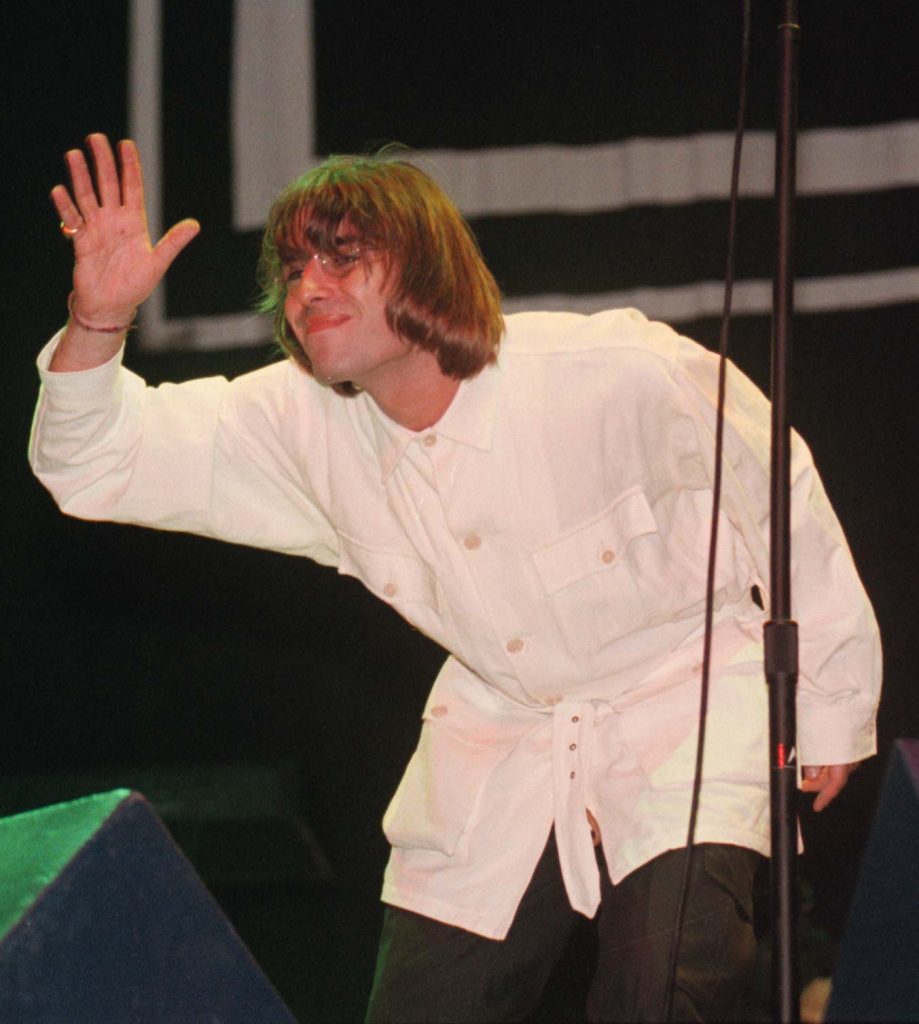 Liam Gallagher waves at the audience during the Oasis concert at Knebworth in Hertfordshire.