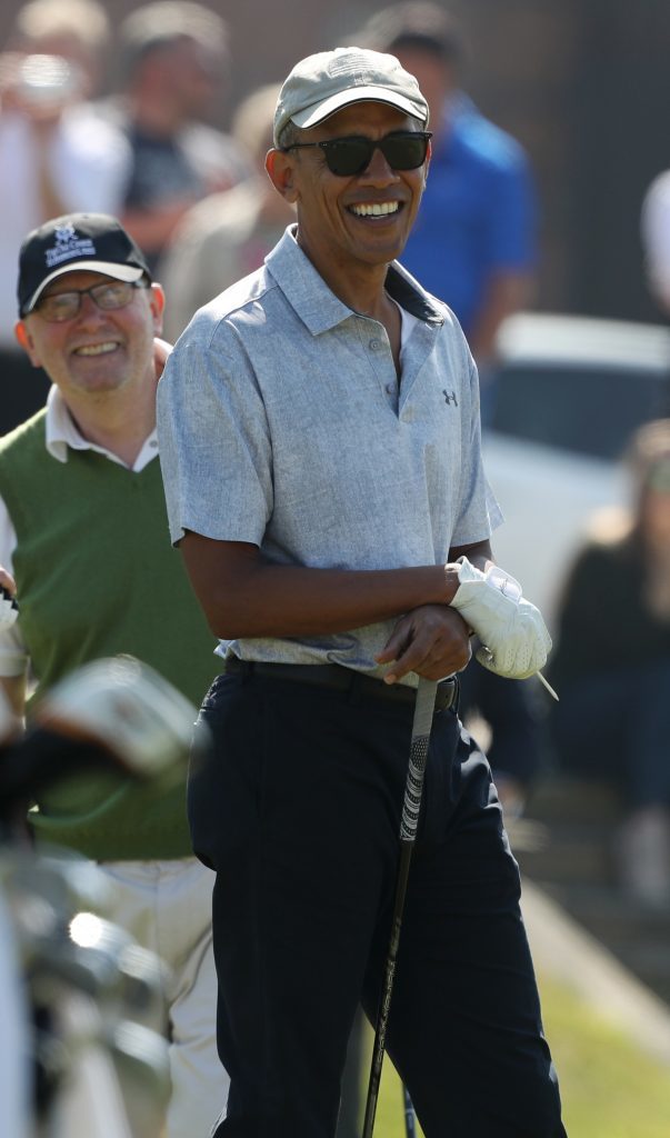 Former US president Barack Obama prepares to tee off at the first hole at St Andrews Golf Club.