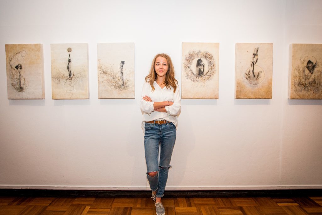 Picture shows Daria Zadarnowska (aged 23) alongside her piece about spirituality using Encaustic wax.