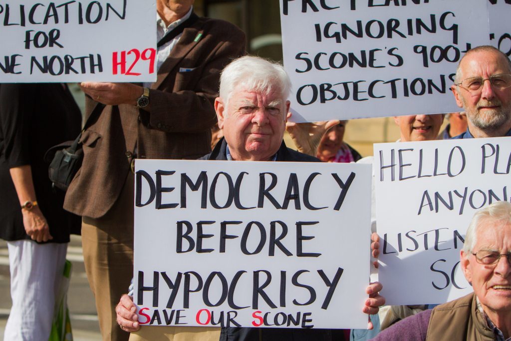 Protests before council meeting regarding housing application for Scone.