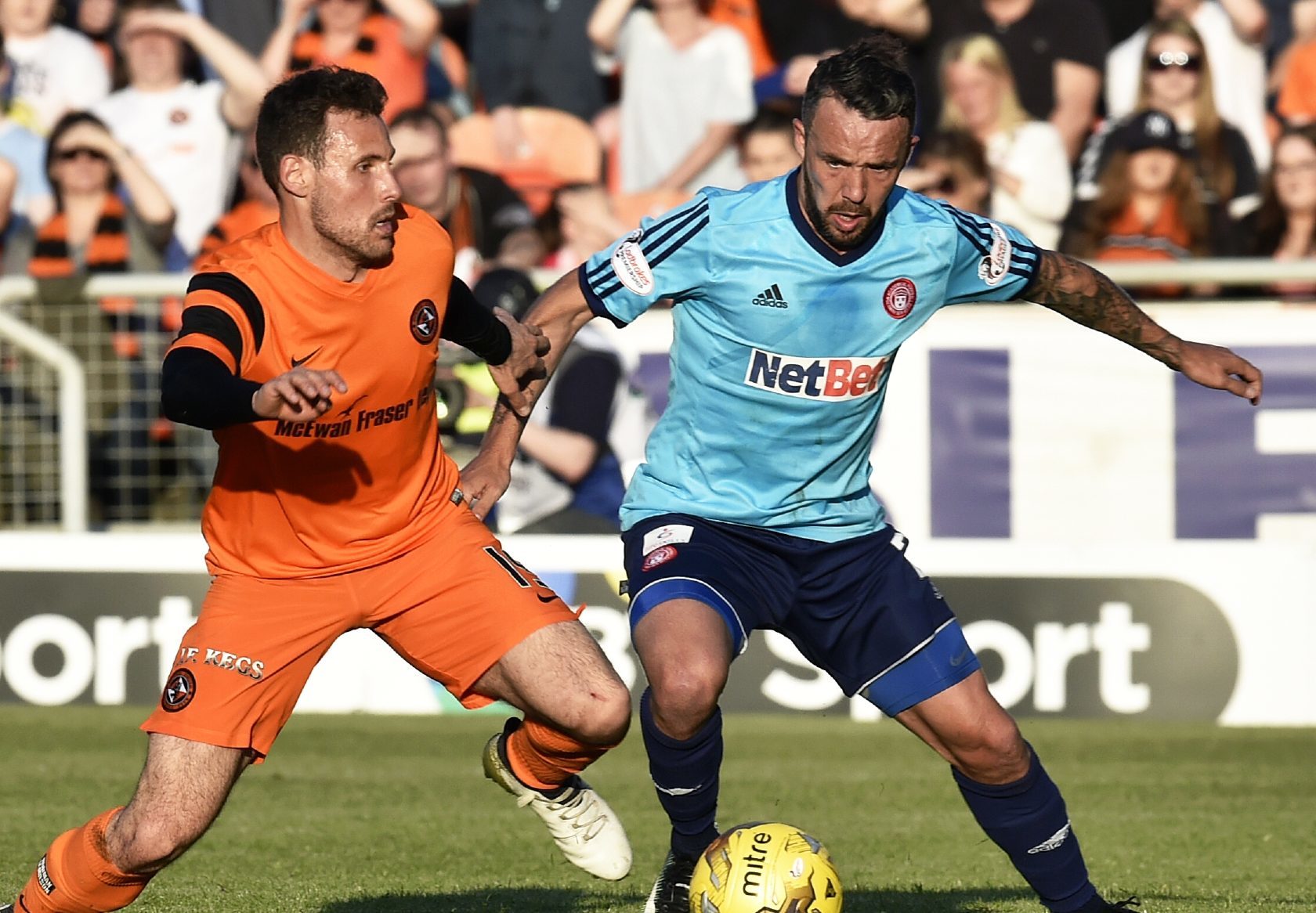 Dougie Imrie holds off Tony Andreu of United.