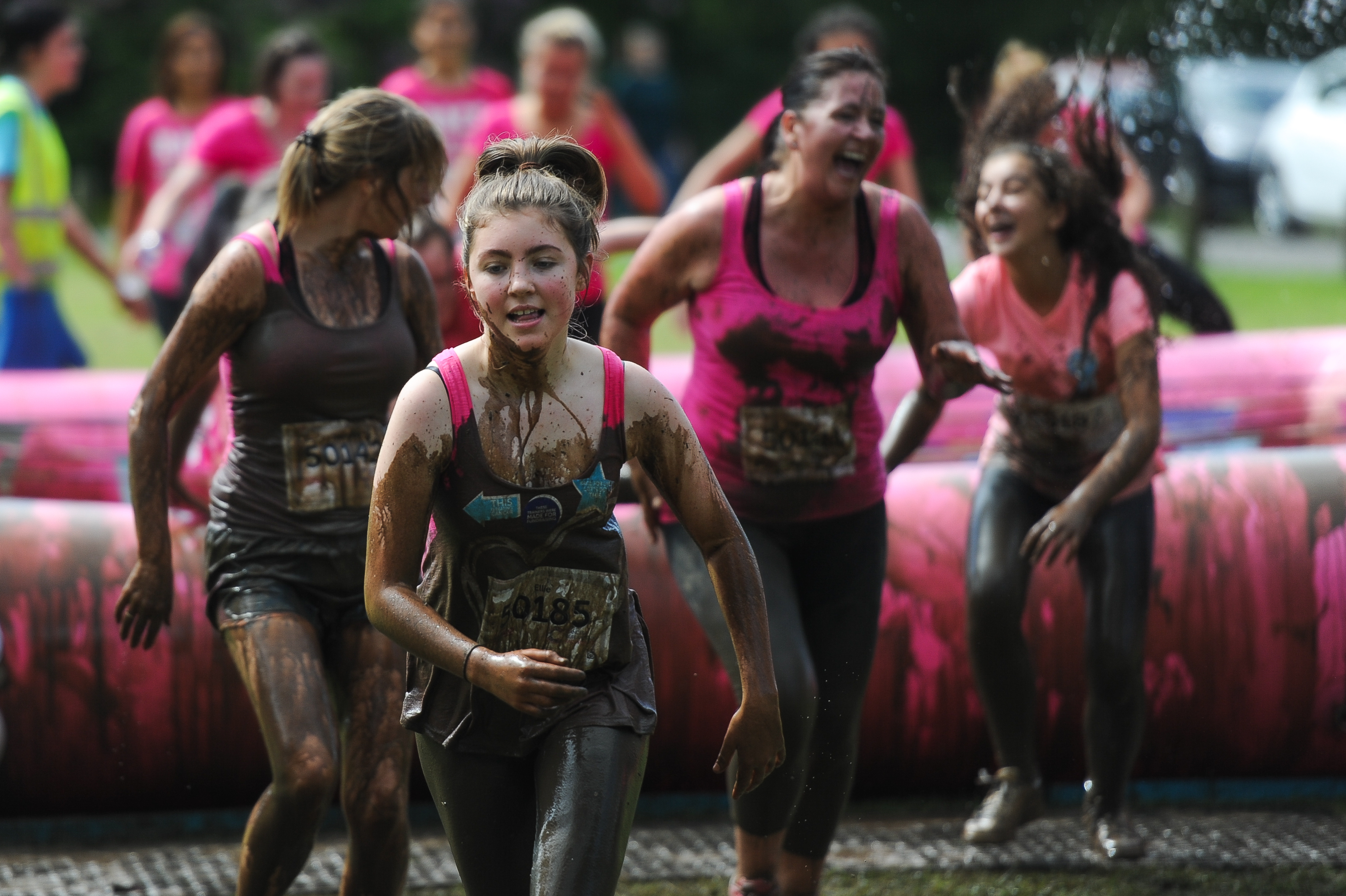 Runners caked in mud during Saturday's Pretty Muddy event.