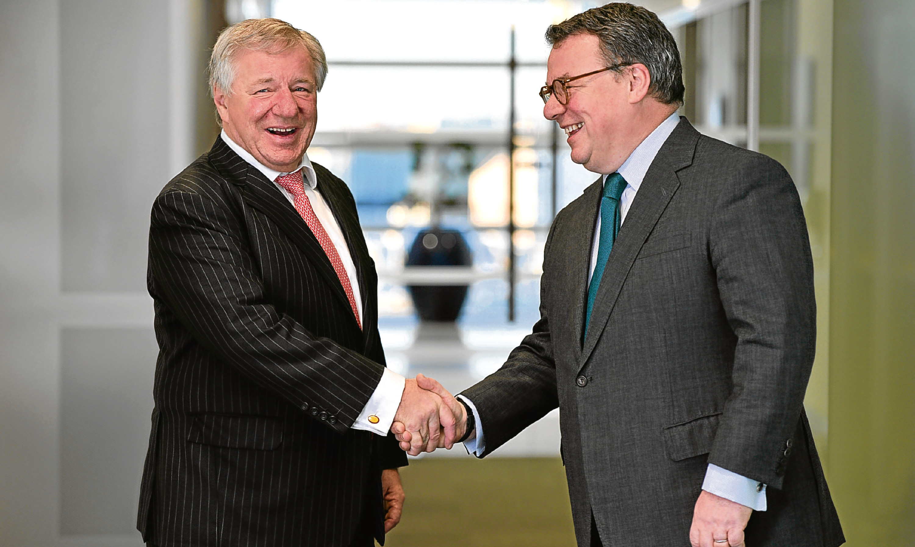 Keith Skeoch, Standard Life CEO, (right) and Martin Gilbert, Aberdeen Asset Management CEO, shake hands after the annoucement of the all share merger in February. They will be joint chiefe executives of the new enlarged firm.