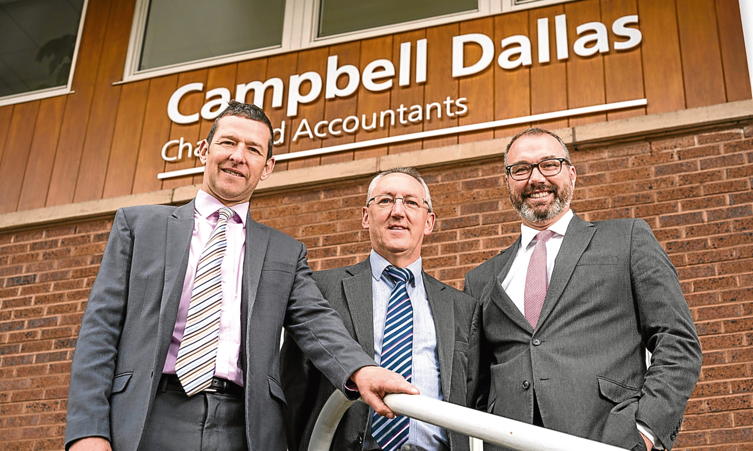 Andy Ritchie, Charlie Carnegie and Chris Horne outside Campbell Dallas Perth office after finalising the acquisition of Bell & Company.