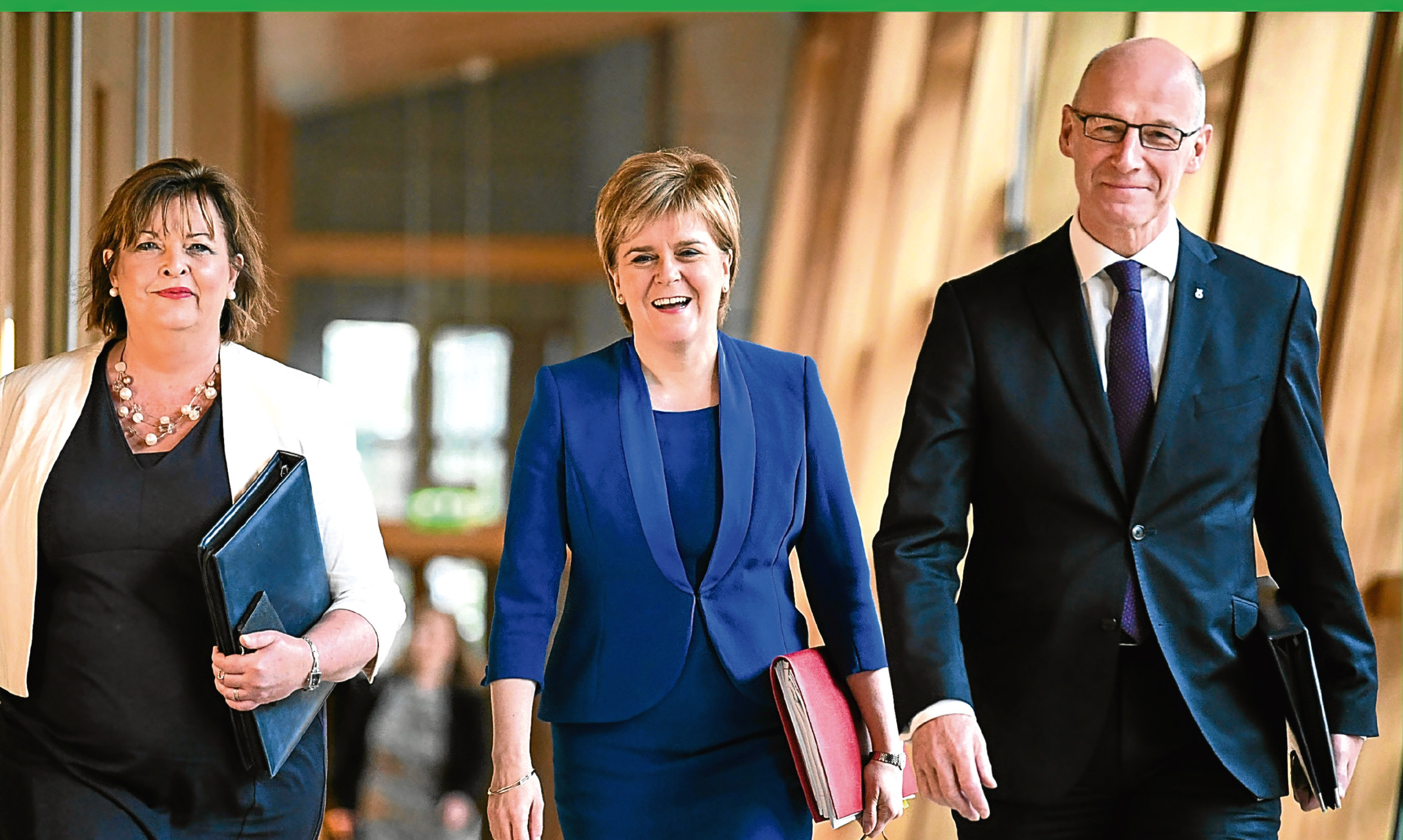 First Minister Nicola Sturgeon with cabinet secretaries Fiona Hyslop and John Swinney before making her statement on Tuesday.