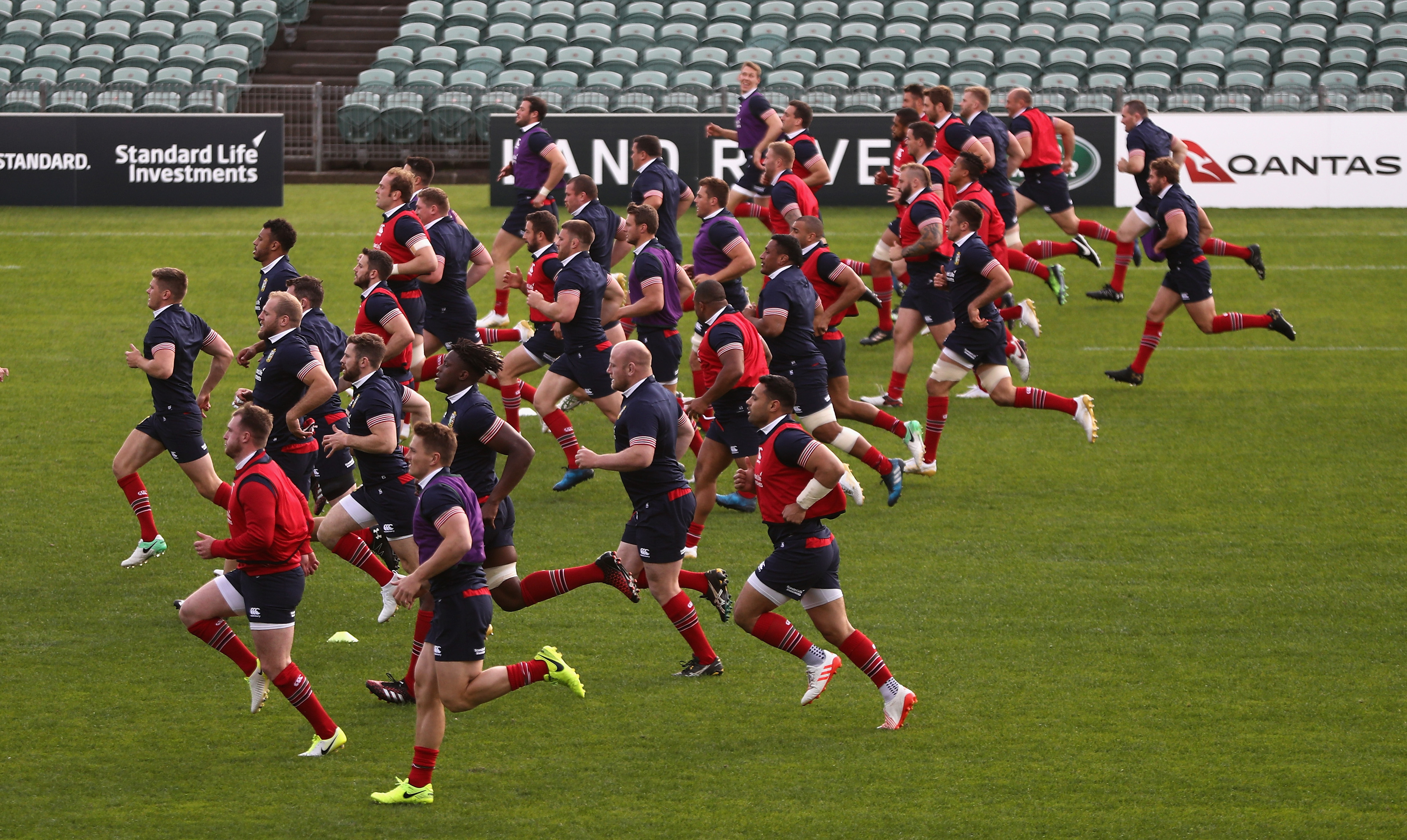 The Lions do a mass-up warm up in training at the QBE Stadium in Auckland.