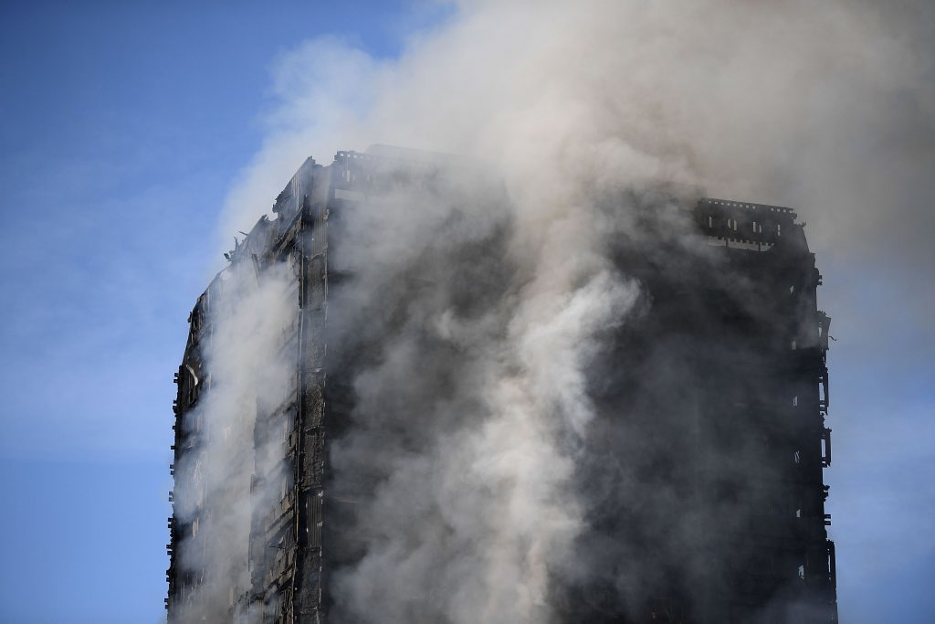 Smoke rises from the building after a huge fire engulfed the 24 story Grenfell Tower in Latimer Road, West London.