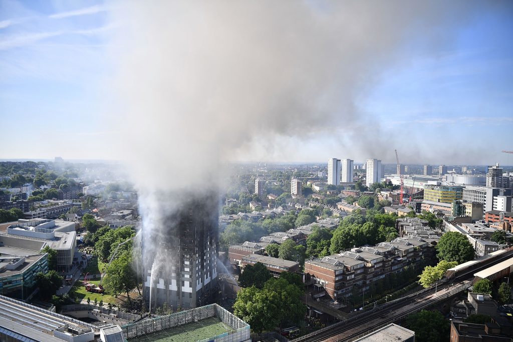 Smoke rises from the building after a huge fire engulfed the 24 story Grenfell Tower in Latimer Road, West London.