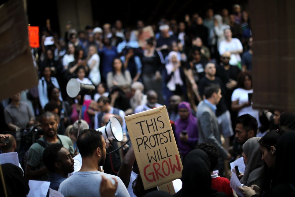  Protesters gather outside of Kensington Town Hall on June 16, 2017 in London, England.