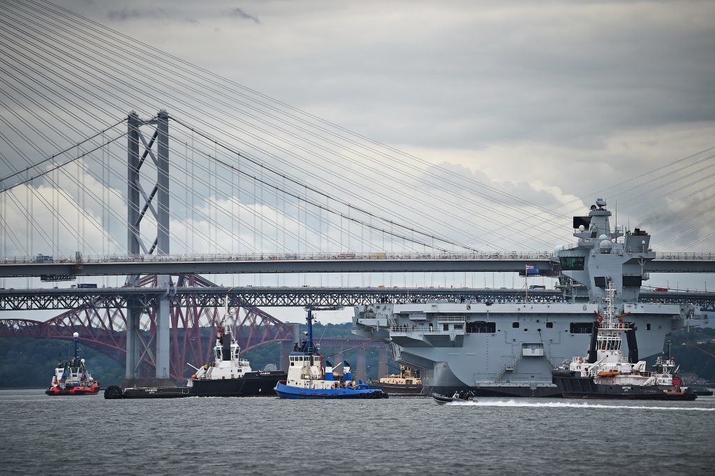 The new Royal Navy aircraft carrier, HMS Queen Elizabeth, departs Rosyth dockyard to be tested in the North Sea. 