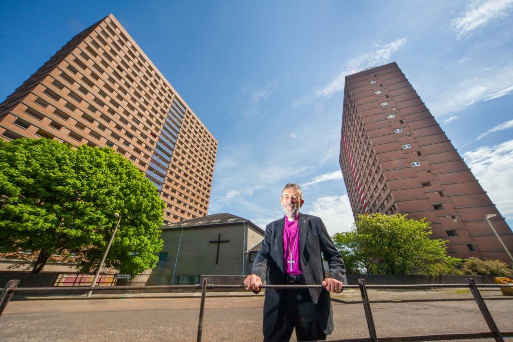 Dundee's Derby Street flats faced demolition in 2013 with the tiny St Martin's Church dwarfed by it's neighbours in the middle. Rt Reverend Nigel Peyton, pictured in front of the Episcopal Church, had faith that his little church would be protected by the demolishers - and it was! 