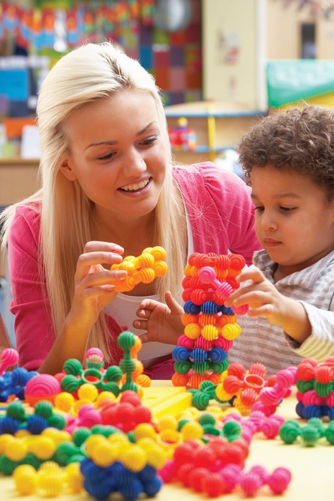 Young woman playing with boy