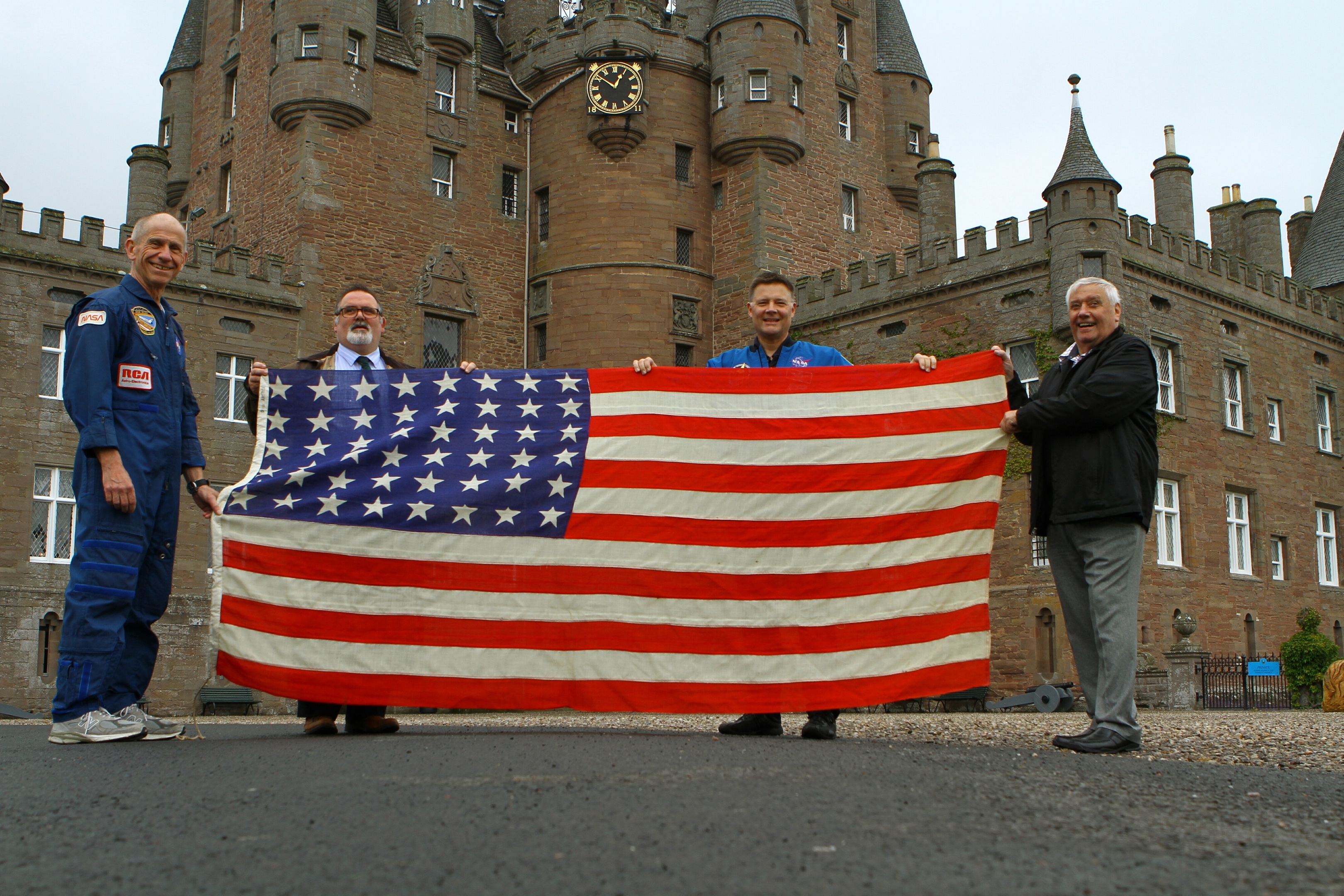 Picture shows former astronaut Bob Cenker, Tommy Baxter, general manager of Glamis Castle, astronaut Doug Wheelock and John J Smith MBE former NASA employee, at the handover of the American flag from Glamis Castle, which will be taken into space.