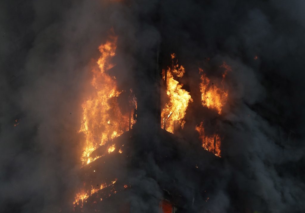 Smoke and flames rise from a building on fire in London.