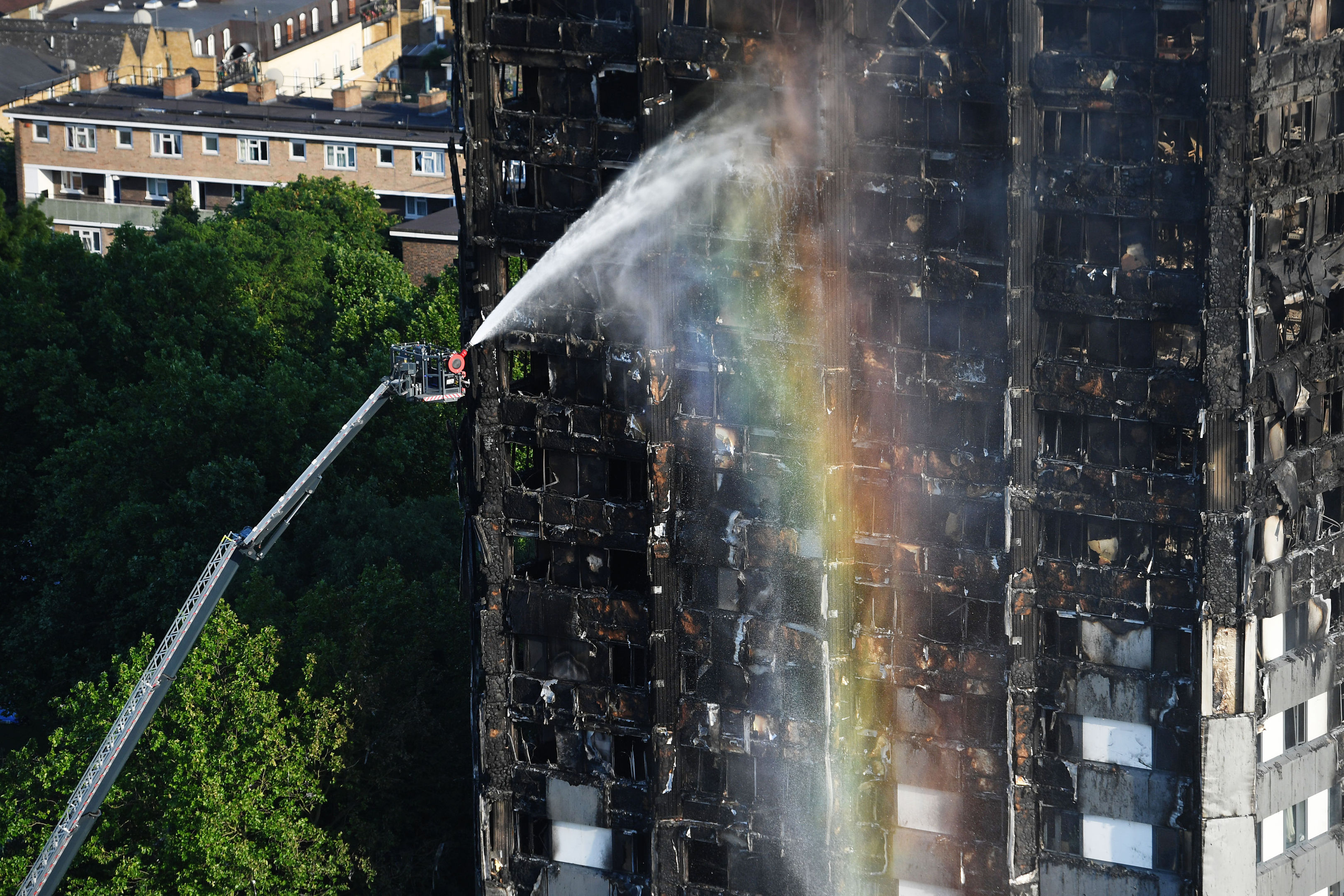 Firefighters spray water after a fire engulfed the 24-storey Grenfell Tower in west London.