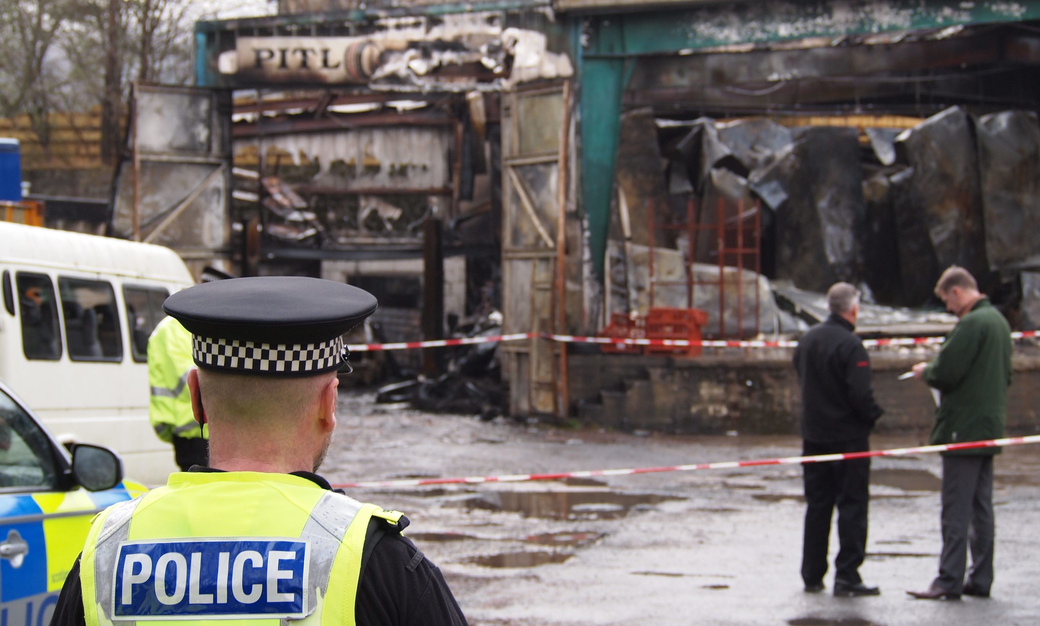 Police probe the blaze at the Hubertus game factory in January 2016.