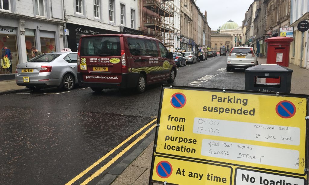 Signs alerting motorists to parking restrictions on George Street, Perth.