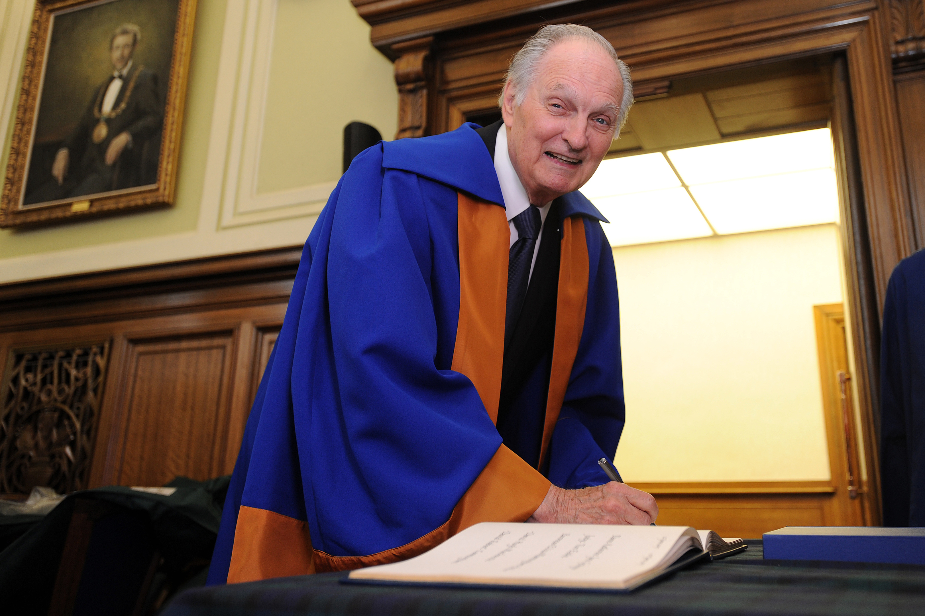 Honorary Graduand Alan Alda signs the book of honorary graduates, City Chambers.