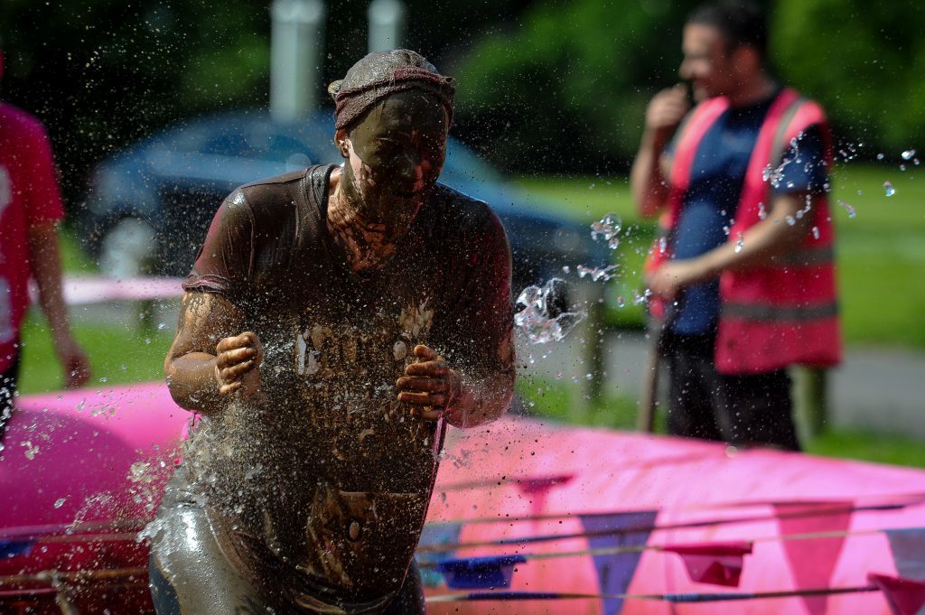 A very muddy competitors at the, Race for Life charity fundraiser for cancer research.
