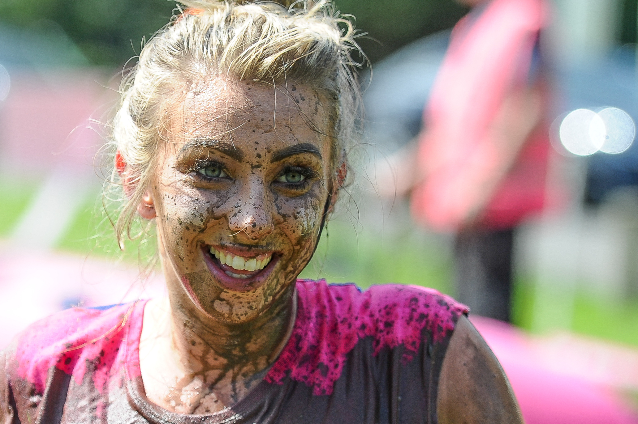 A happy runner braving the mud.