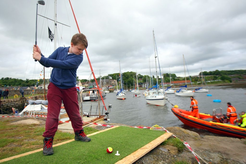 Keiron Malloch trying his hand at river golf at the Limekilns River Festival.