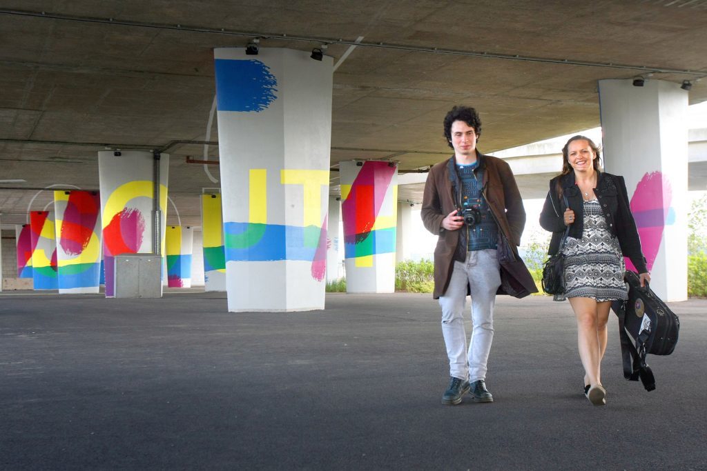 Tay Road Bridge columns with passers-by Julian Joseph and Laura McGhee.