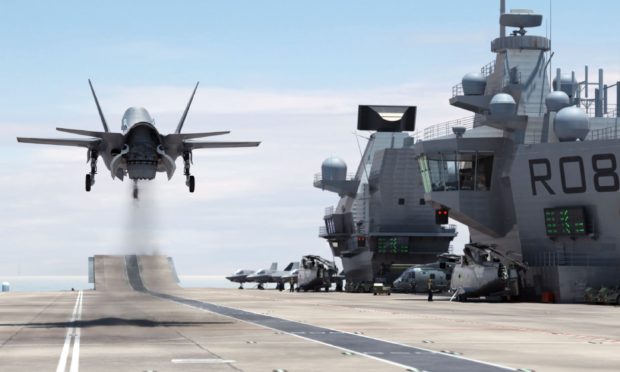 A F-35B Lightning II jet landing vertically on the Royal Navy's new aircraft carrier HMS Queen Elizabeth.