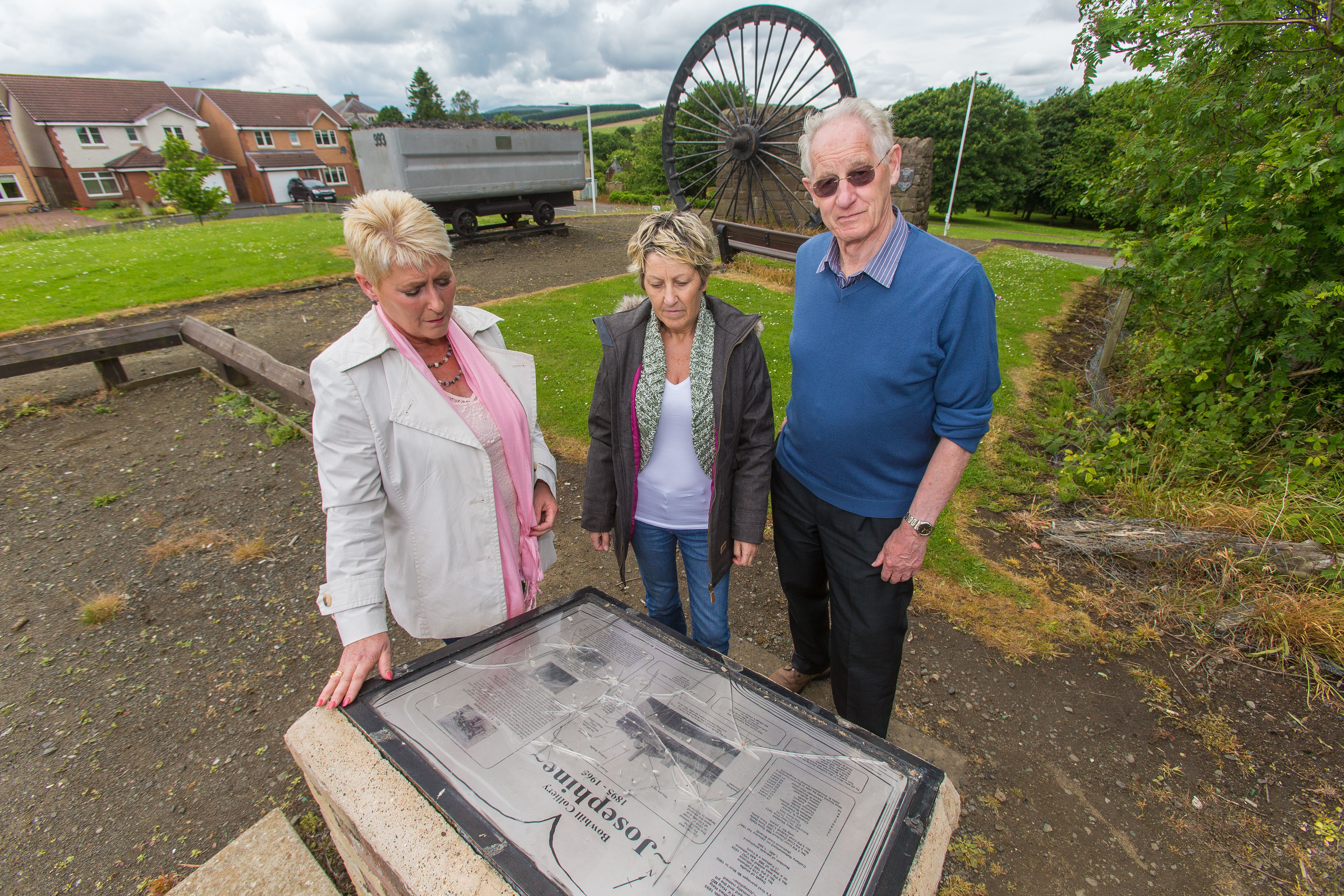 Cllr Rosemary Liewald, Angie Roy of the residents' association and community council secretary David Taylor at the memorial which has been vandalised.