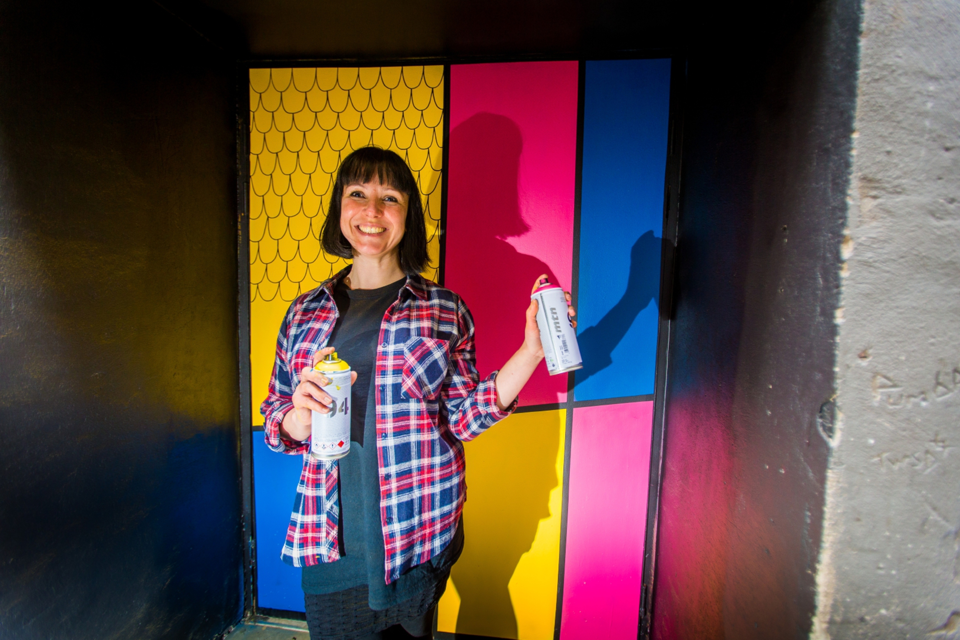 Suzanne Scott in front of her colourful artwork on Couttie's Wynd.