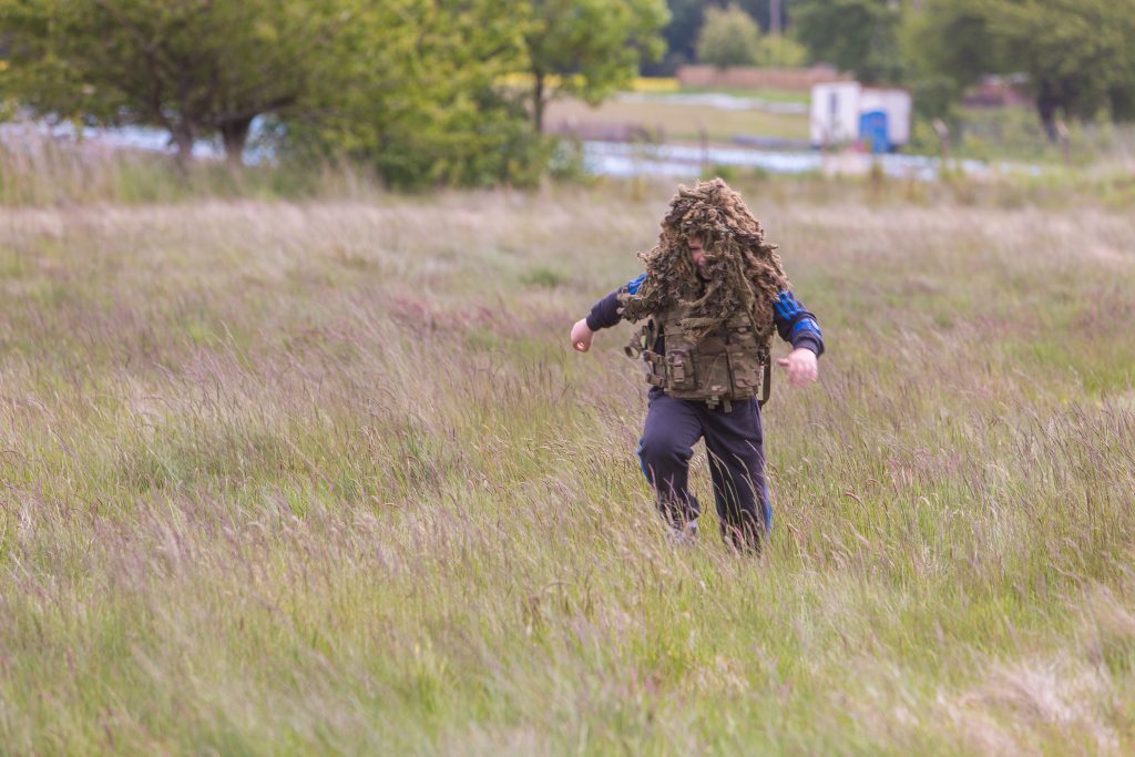 Picture Shows: Brodie Allan (12) from Forfar Academy runs about in the soldiers body armour and hides.