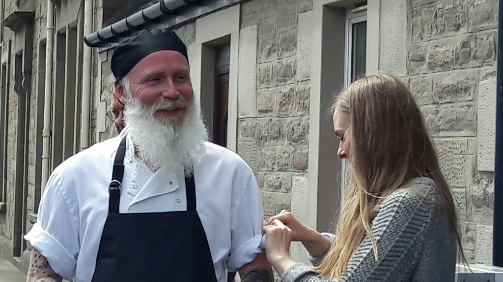 Actor Dave Dixon shares a joke with stylist Zoe Radcliffe before a shoot