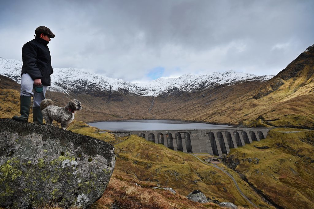  A boy and his dog view Cruachan hydro electric power station in Argyll on March 30, 2016.