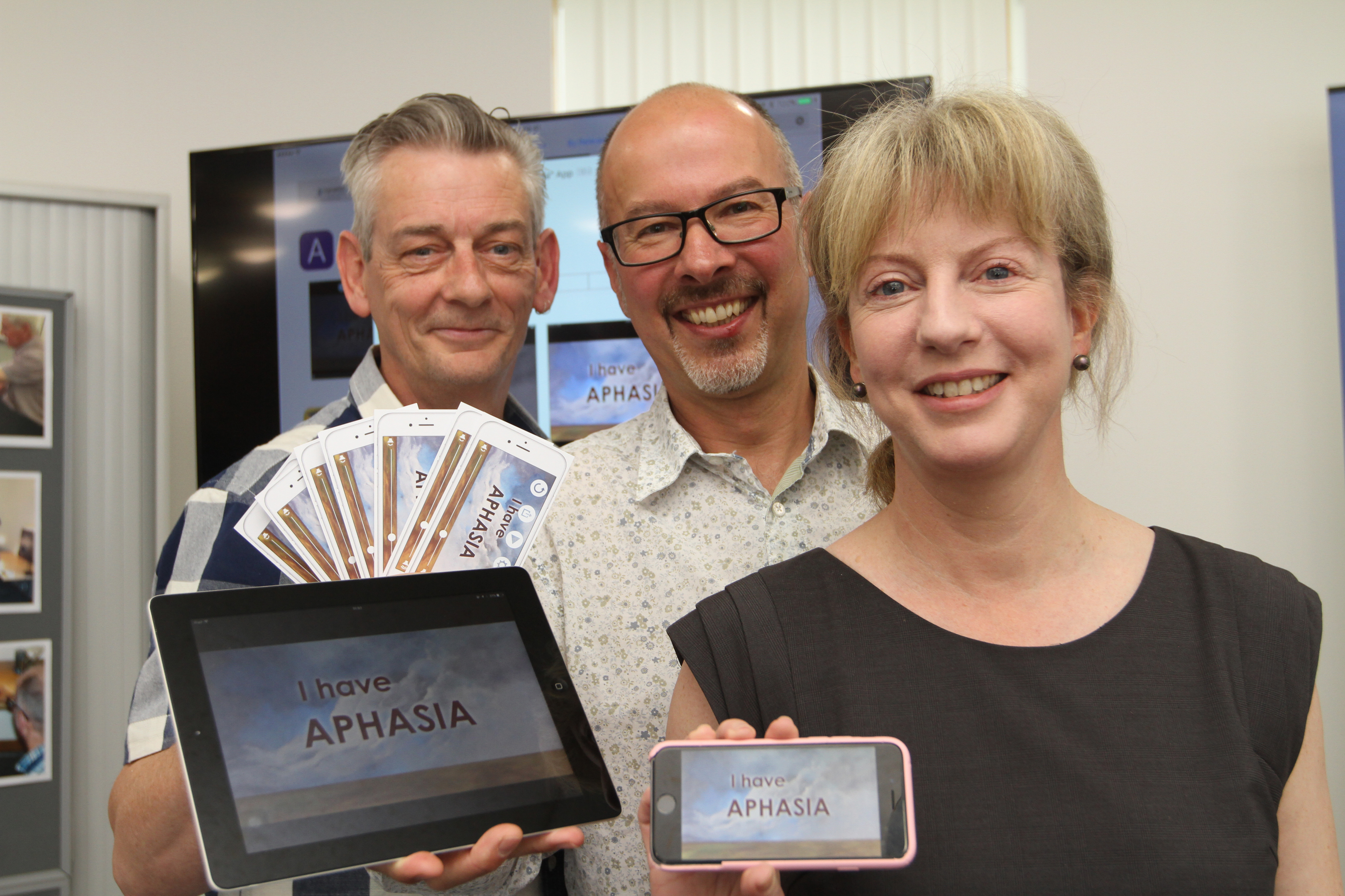 Health secretary Shona Robinson with project coordinator Chris Kelly and Rolf Black, project leader for Aphasia Ipad Group