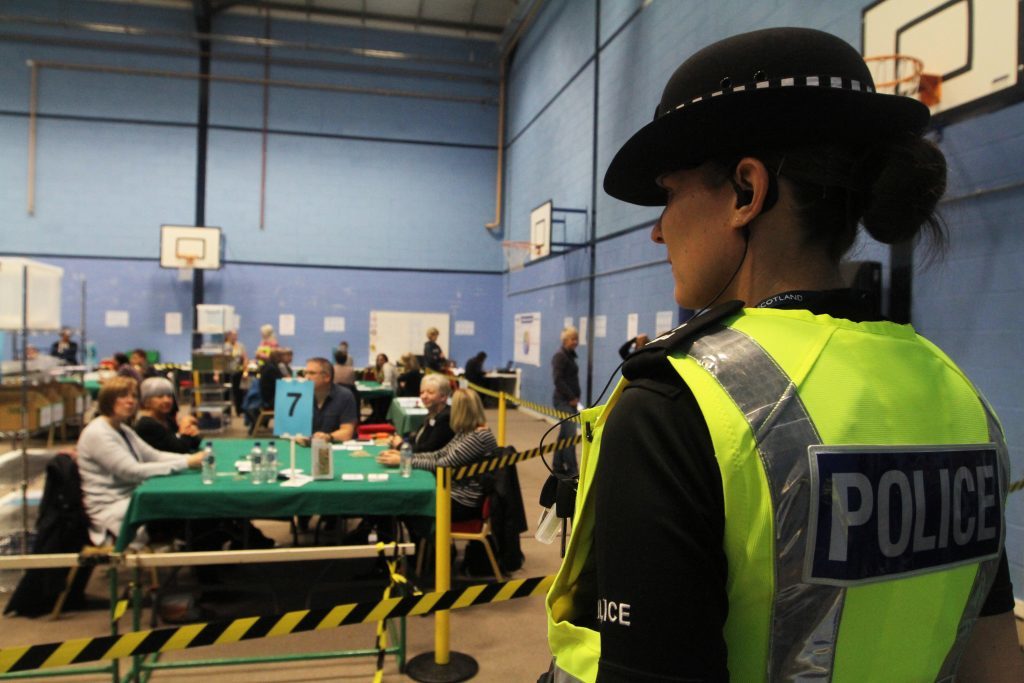 Police stand watch at the count.