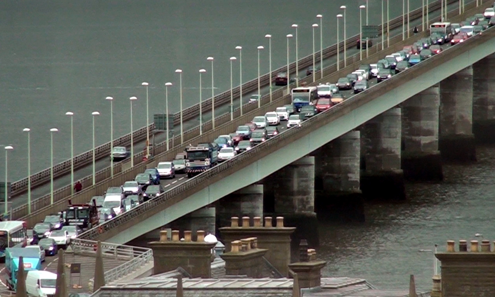 Reports suggest a car has become lodged under a crash barrier at the Fife side of the bridge.