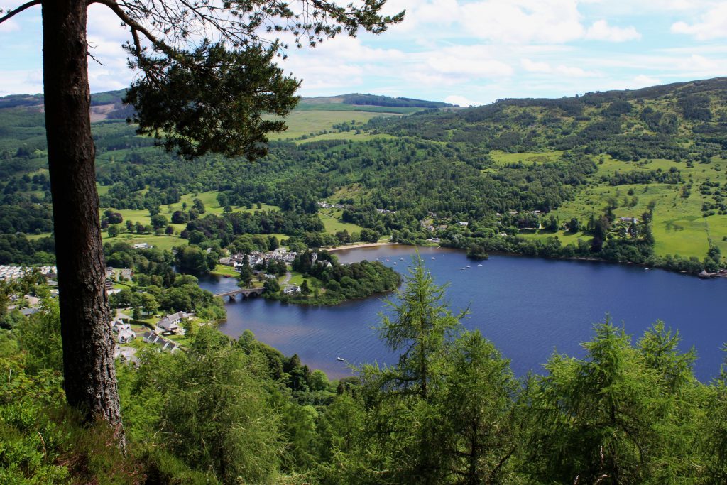 View of Kenmore, sitting on edge of Loch Tay, with bridge crossing River Tay at its east end.