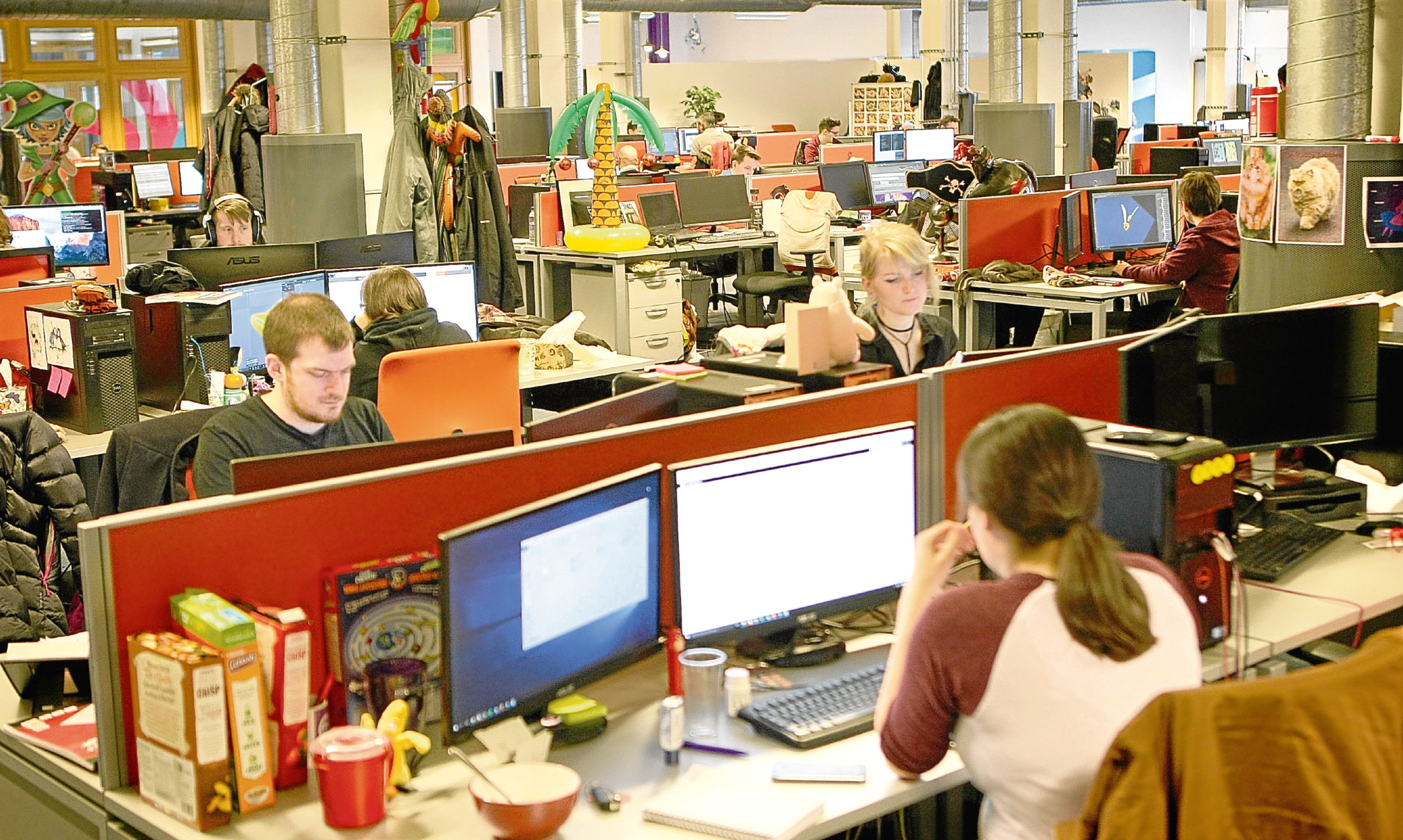 Members of the Outplay team at work in the Dundee studio