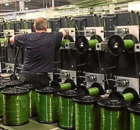 A technician works on the new synthetic grass yarn line at Don & Low in Forfar