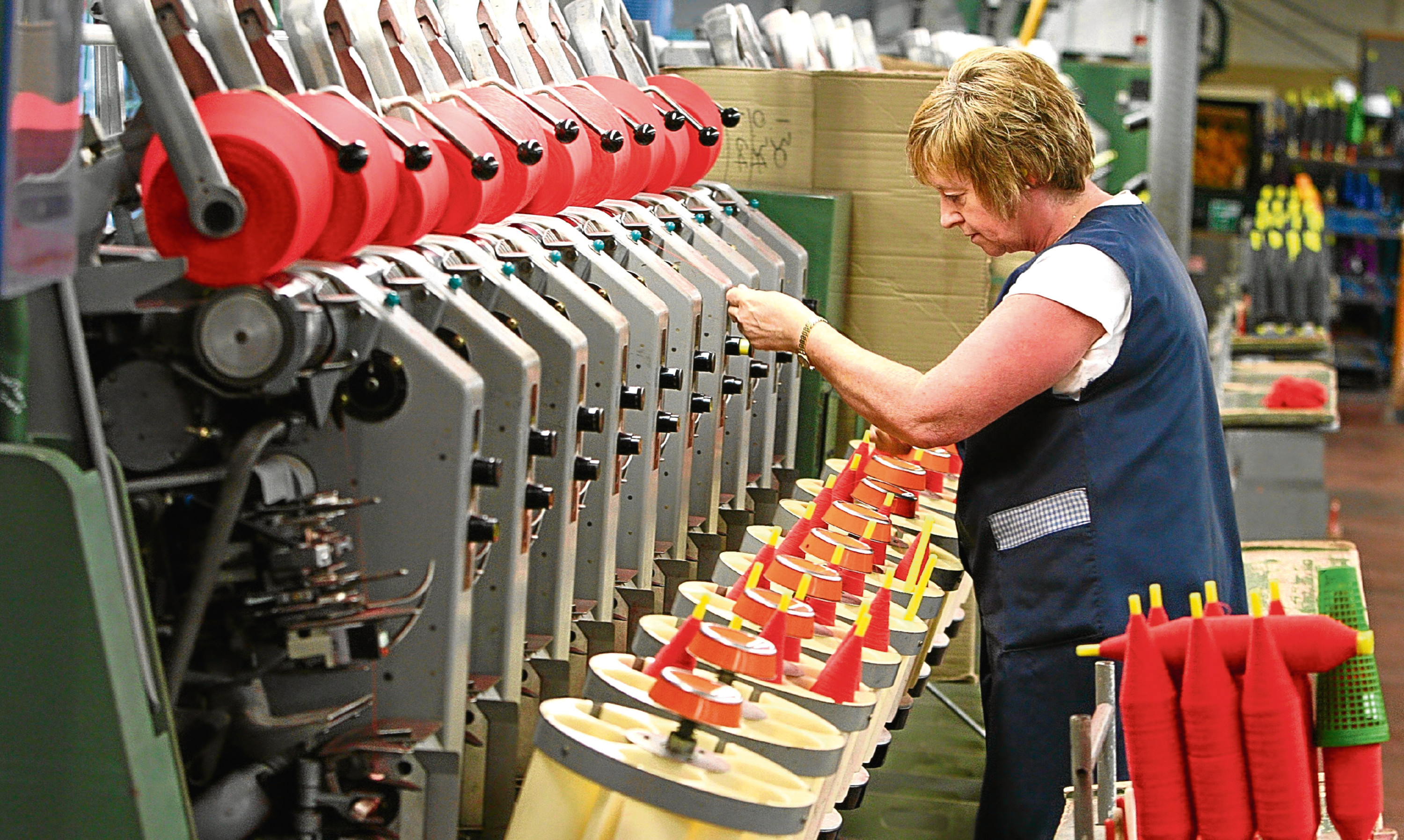 A worker involved in the cashmere yarn manufacturing process at Todd & Duncan's Lochleven Mill in Kinross.