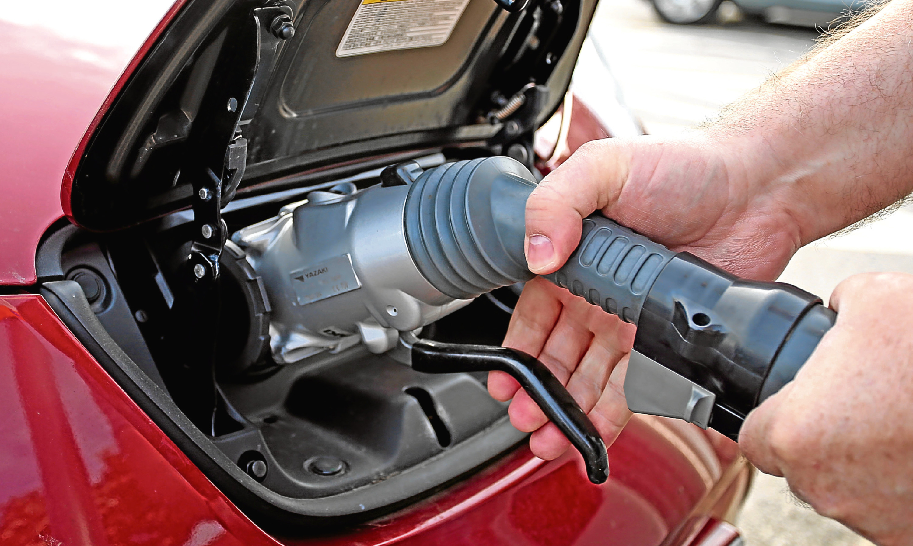 A car is refuelled at an electric charging point.