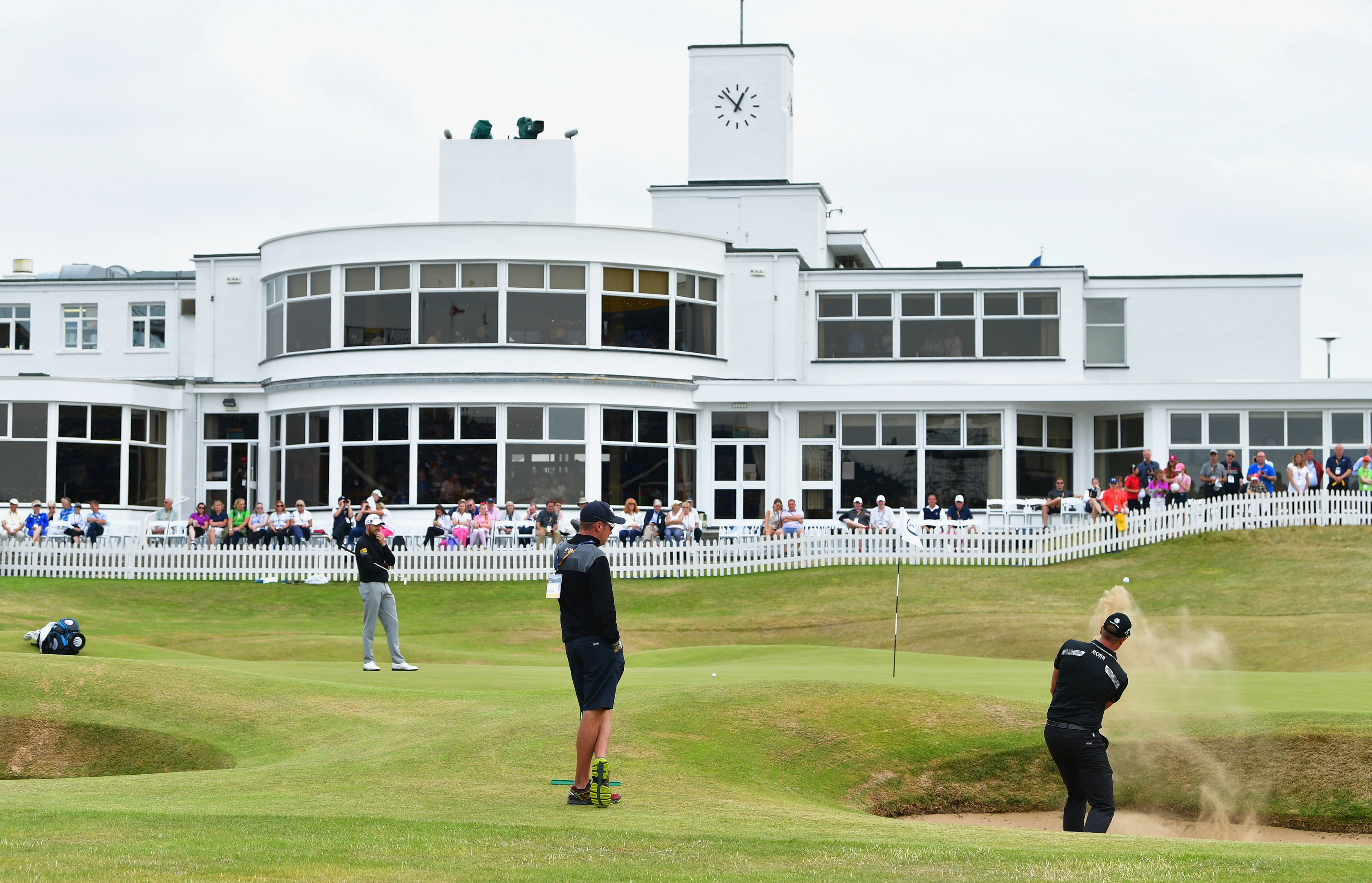 Defending champion Henrik Stenson hits a bunker shot in front of the clubhouse at Royal Birkdale.