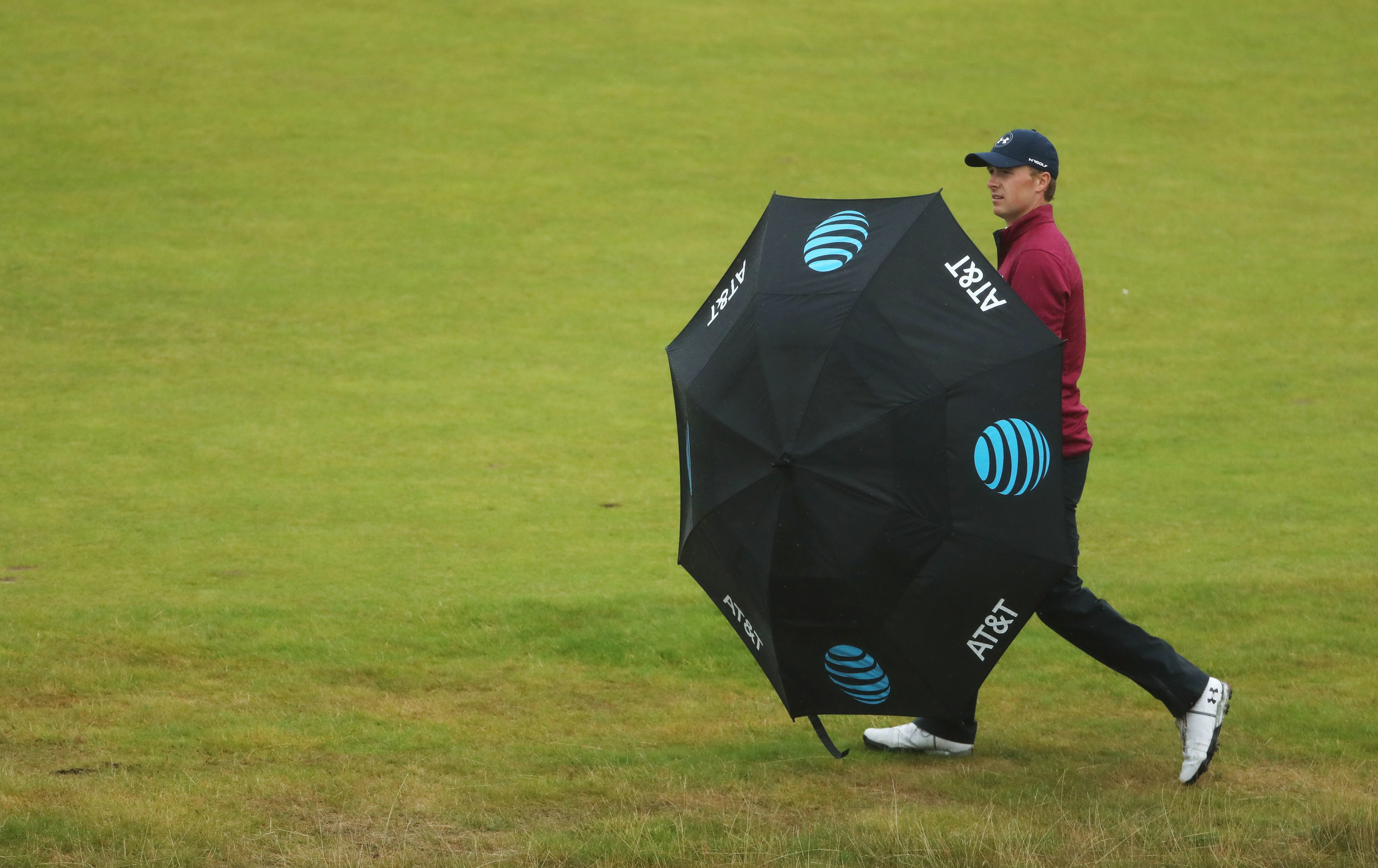 Jordan Spieth shelters from the rain under an umbrella during the second round at Royal Birkdale.