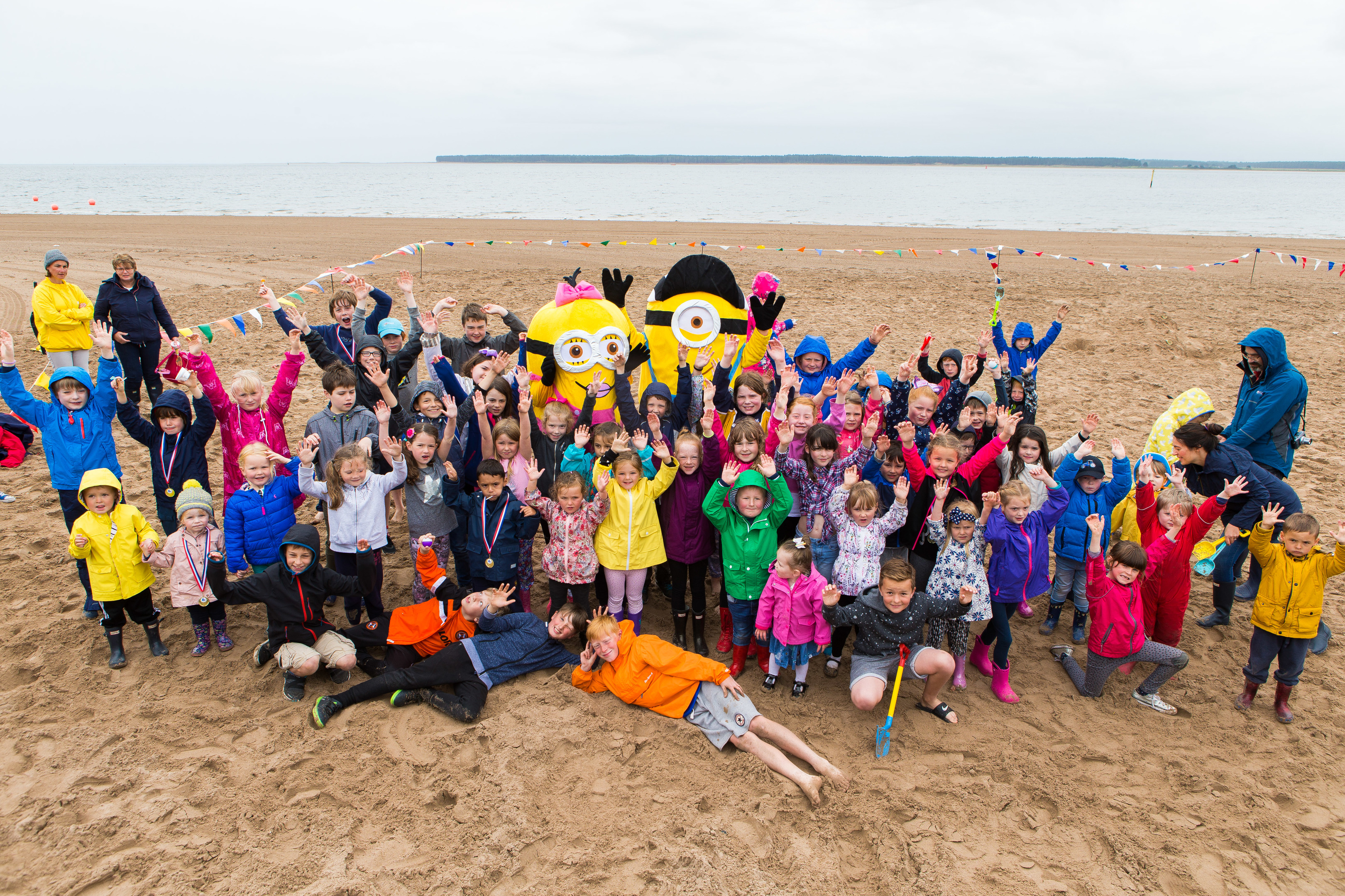 Kids having fun at the buried treasure hunt on the beach.