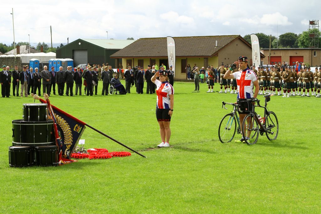 Officer Cadet Emily Whyte and WO1 Kevin Stacey of the cyclists who went from Crieff to Passchendaele, saluting after laying their wreath.